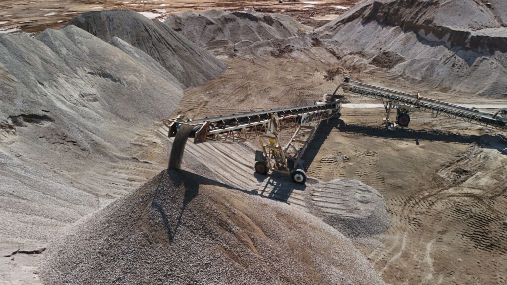 Drone image of aggregate conveyor machine moving gravel at Phoenix construction site.